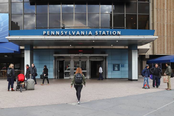 The drab exterior of Penn Station, with the words "Pennsylvania station" on an awning at 32nd Street and 8th Avenue